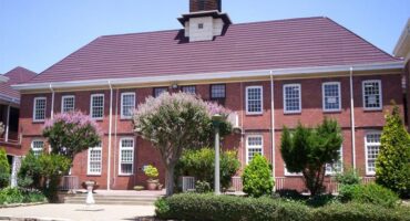 A front view of Willowmoore High School with gardens in the foreground.