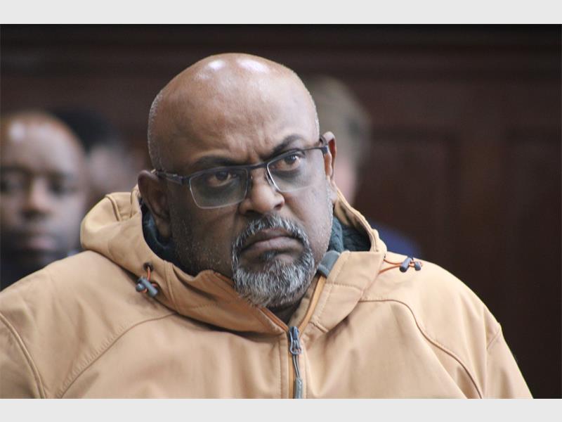 a man wearing a jacket and glasses