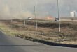 A veld fire causing a lot of smoke next to a road
