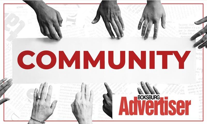 A black and white image of hands of different shades reaching into the word Community in red and the Boksburg Advertiser logo in the bottom right corner.