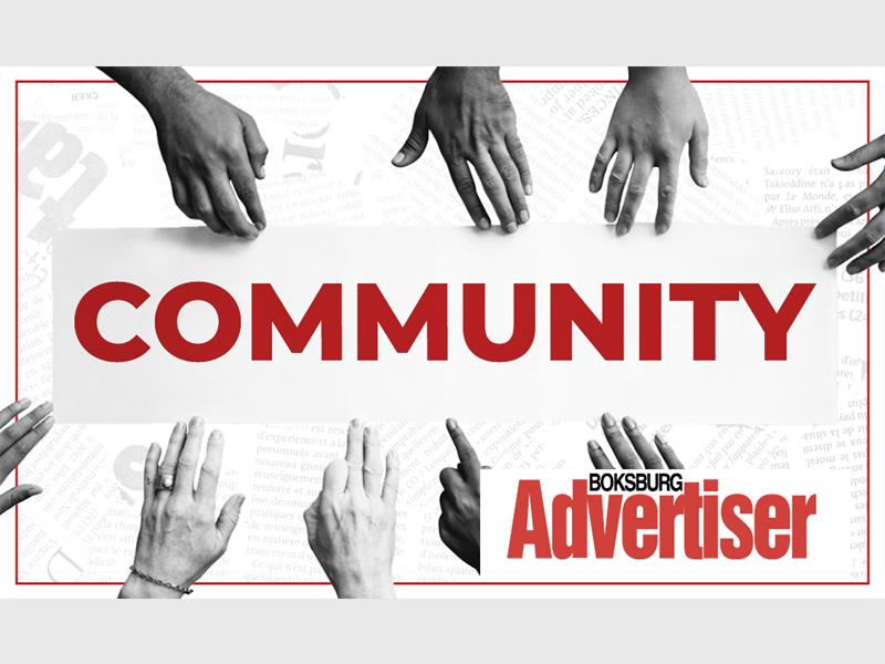 A black and white image of hands of different shades reaching into the word Community in red and the Boksburg Advertiser logo in the bottom right corner.