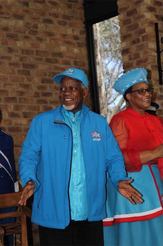 Black man and woman wearing ADCP regalia smiling