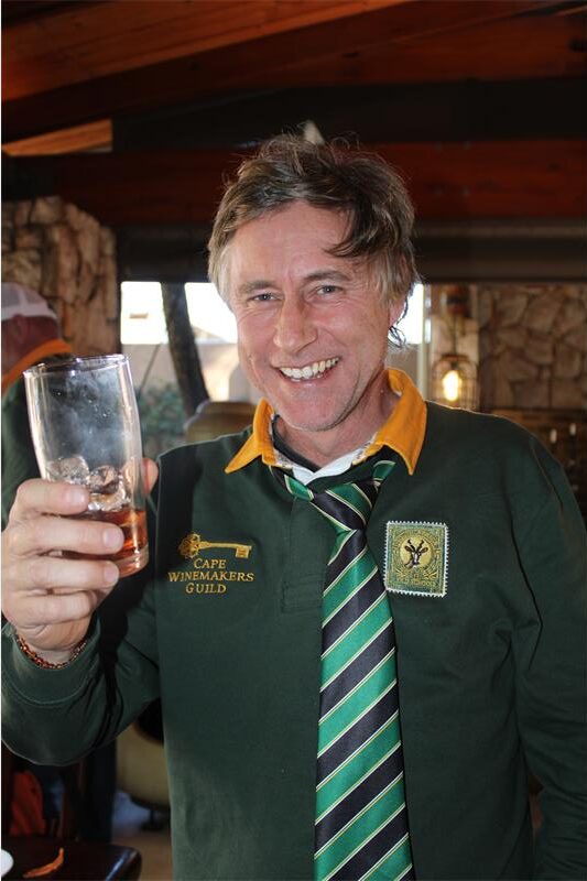 Man wearing a Springbok jersey with his glass held up