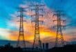 3 electricity pylons photographed with a sunset behind them.