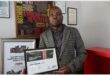a man holding an award certificate