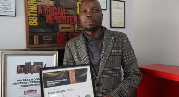 a man holding an award certificate