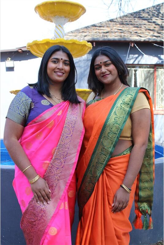 Two Indian women wearing colourful saris