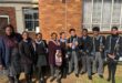 A group of boys and girls in school uniform who are the prefects of the school.