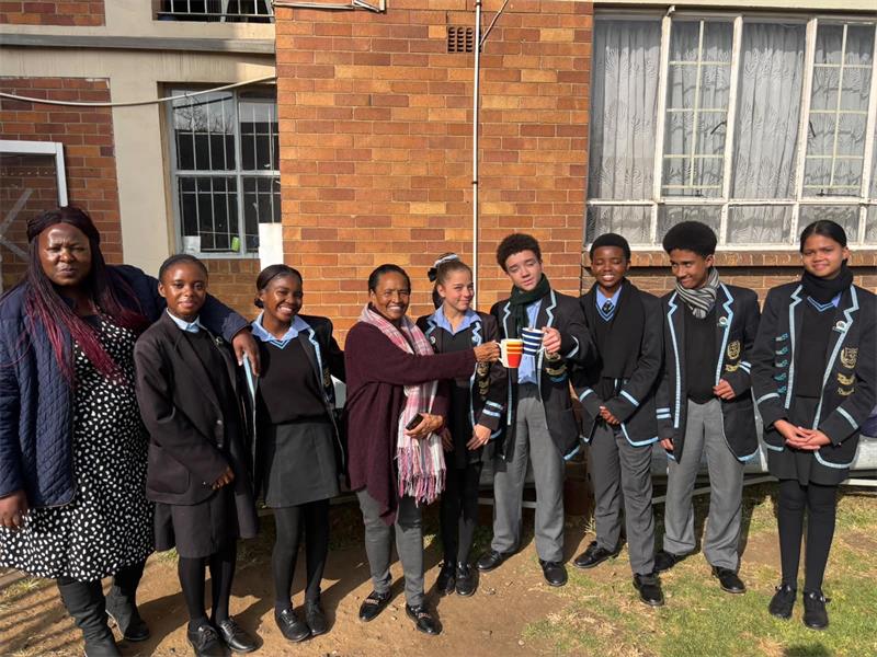 A group of boys and girls in school uniform who are the prefects of the school.