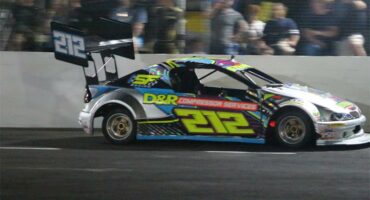 A raceway car on the track marked with the number 212.