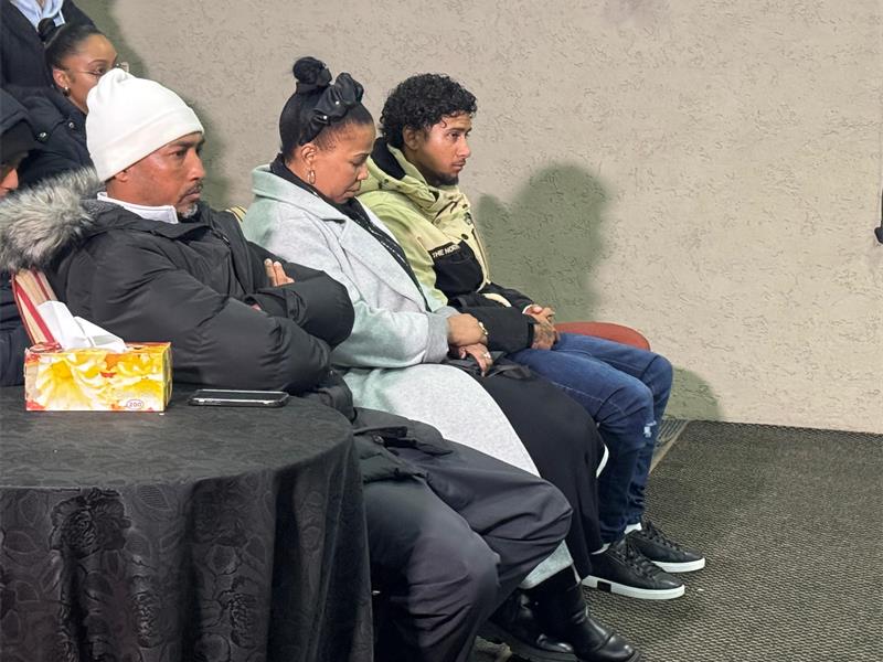 family sitting at the front row of the hall