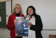 Two women holding a poster