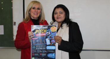 Two women holding a poster