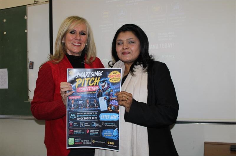 Two women holding a poster