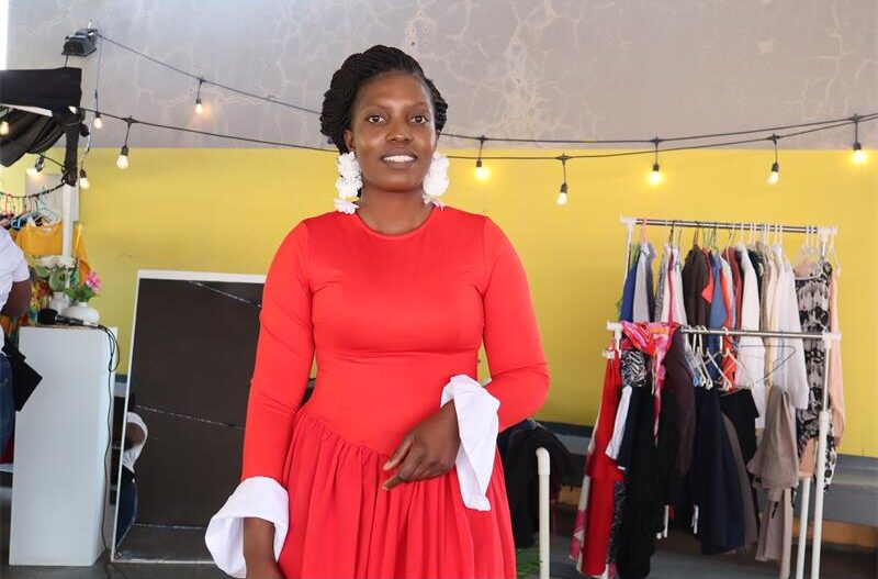Lady in red dress wearing white earrings.