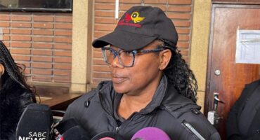 a woman in black top and cap