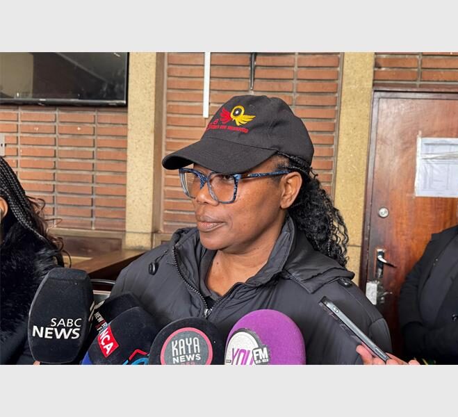 a woman in black top and cap