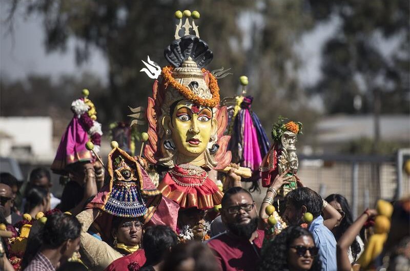 Group of Indian people carrying a deity