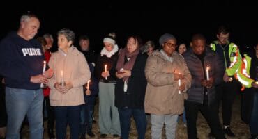 a group of people during a candlelight ceremony