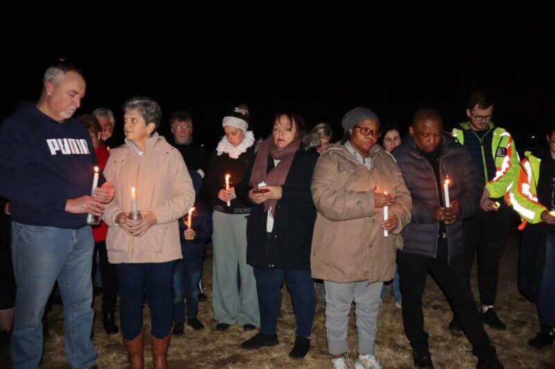 a group of people during a candlelight ceremony