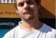 a young man dressed in a white top