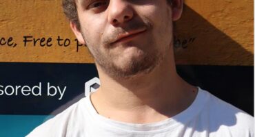 a young man dressed in a white top
