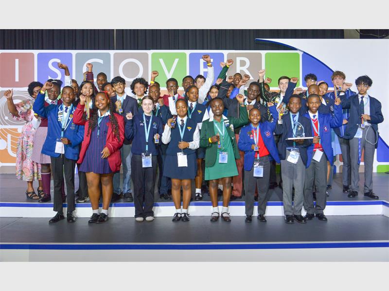 Learners from different schools standing on stage