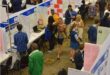 Learners standing at different stalls in a hall