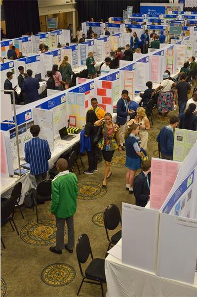 Learners standing at different stalls in a hall