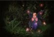 A fairy garden with lights and a fairy.