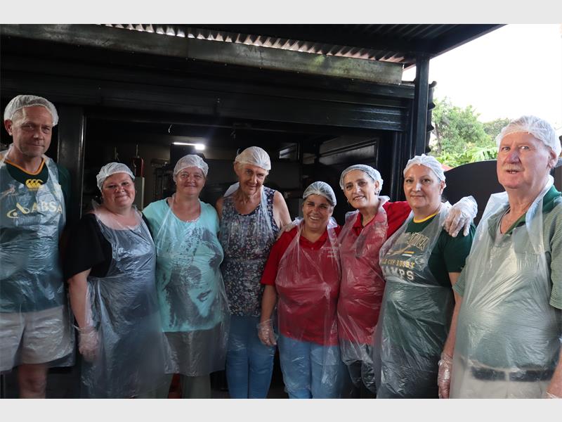 A group of white people wearing kitchen wear.