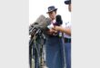 Two black SAPS females in uniform speaking into media microphones