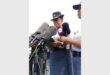 Two black SAPS females in uniform speaking into media microphones