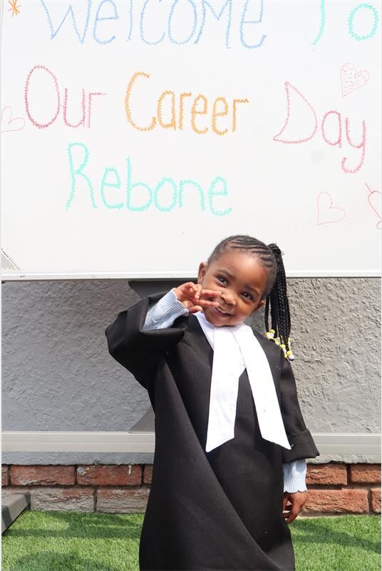 A small girl wearing a lawyers gourmet 