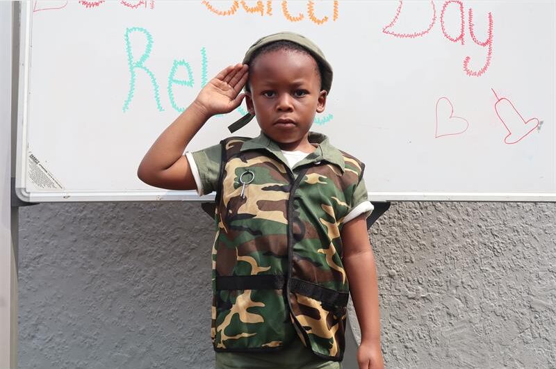 A small boy wearing like a solider 
