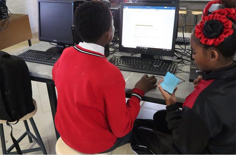 two learners sitting in front of computer screen