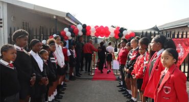 Learners waiting at the entrance of the school to welcome guests