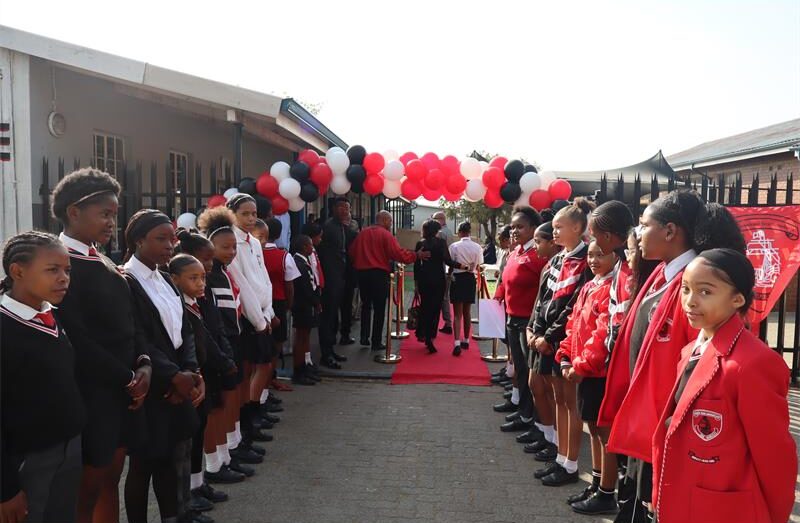 Learners waiting at the entrance of the school to welcome guests