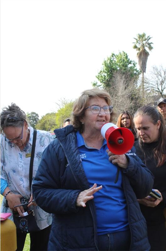 Elderly woman speaking on a loud speaker