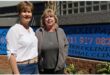 two women standing outside a building
