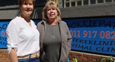 two women standing outside a building