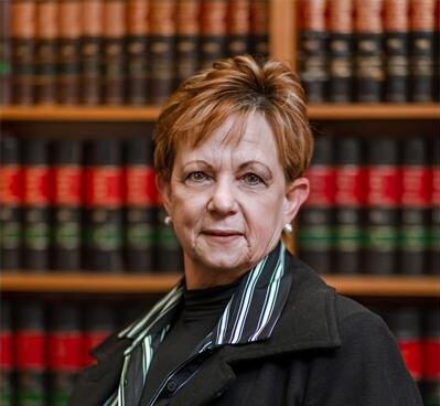 Woman standing in front of a book rack