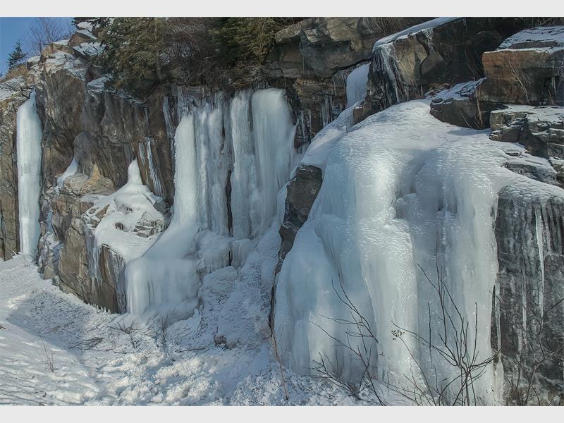 A photo of ice frozen on rocks