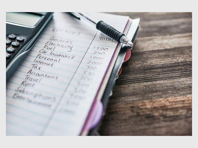 An image of a book with writing on a page and pen lying on top of the page.