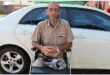White man with grey bread sitting on a wheelchair.