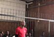Man standing by the dock wearing a red tshirt