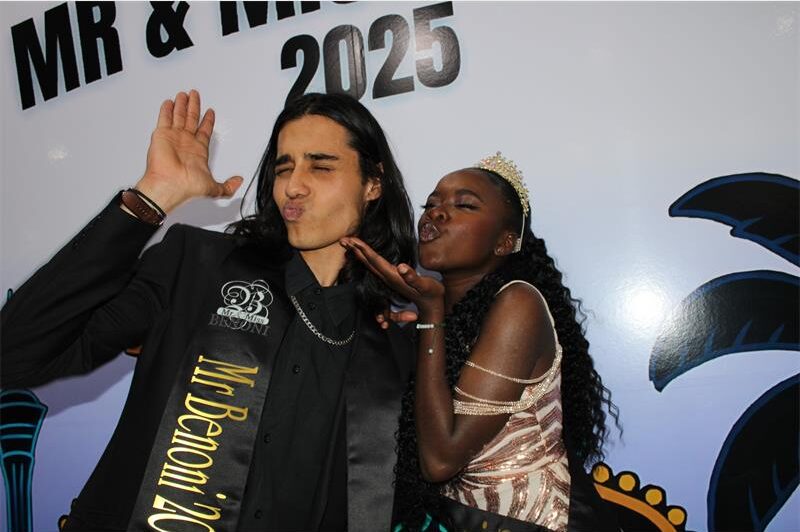 Indian man an black lady in formal attire blowing kisses