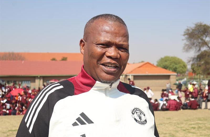 Man with short hair and adidas jacket