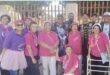 Group of coloured women wearing pink and purple