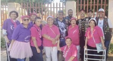 Group of coloured women wearing pink and purple